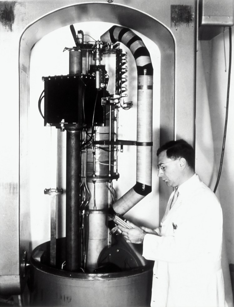 Dr. Henry Kaplan, in the 1950's, with an early model of the Linear Accelerator developed to treat cancer. For this picture the protective hood was removed, revealing the electronic insides of the six-million volt machine, used for radiation treatment. 1950